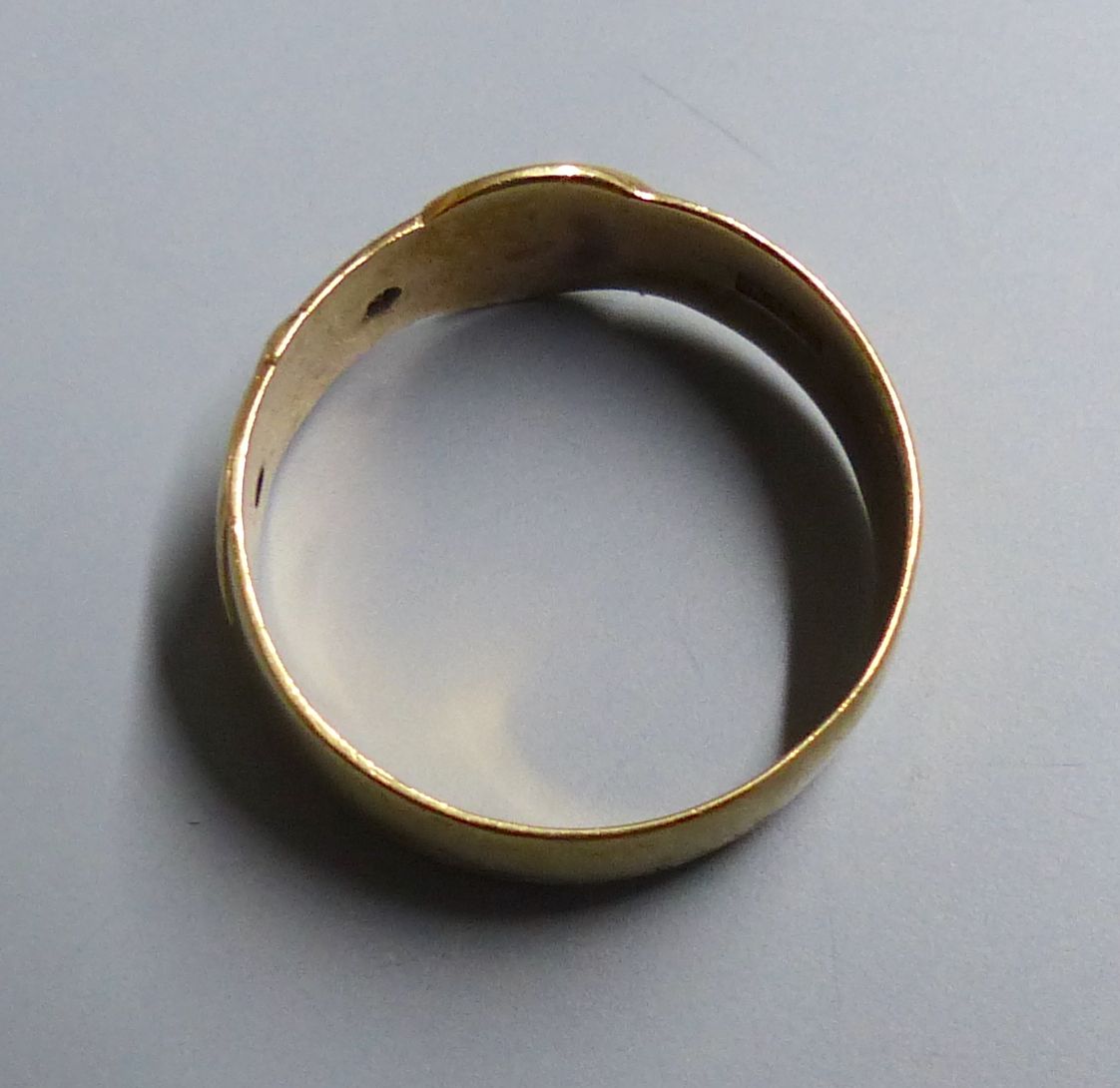 A modern 9ct gold and two white stone chip set buckle ring, size U/V, gross 5.1 grams.